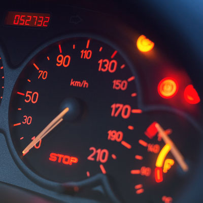 Car dashboard warning lights indicating serious electrical system problems